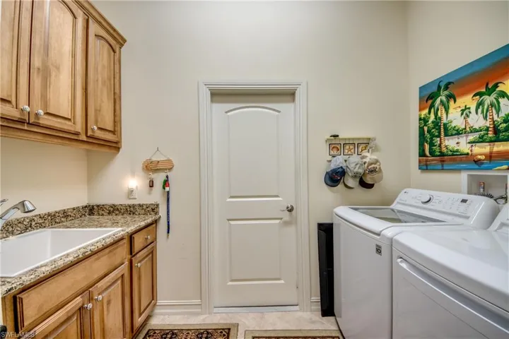 Laundry area featuring washer and dryer and cabinet space