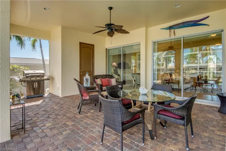 View of patio / terrace with a ceiling fan, area for grilling, and outdoor dining space