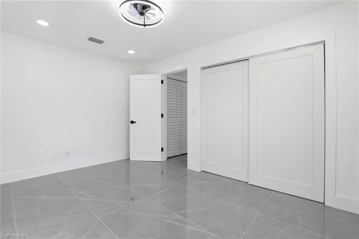 Unfurnished bedroom with recessed lighting and a closet