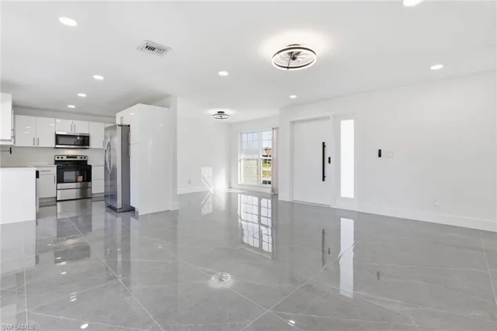 Unfurnished living room featuring recessed lighting