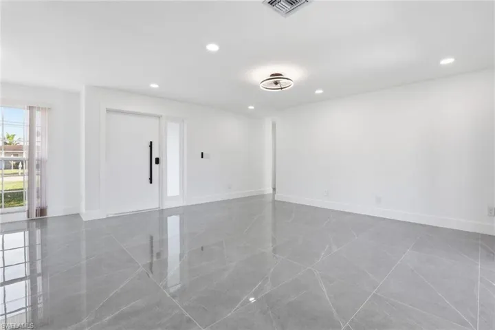 Living room with recessed lighting and baseboards