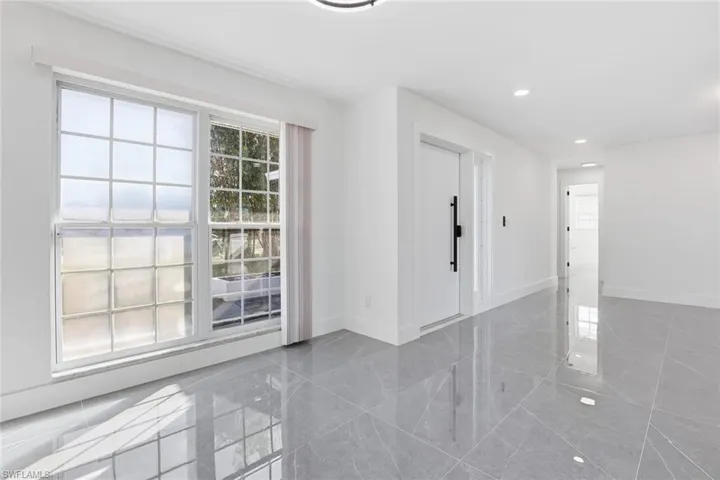 Empty room with baseboards and recessed lighting