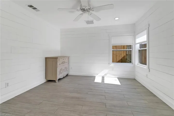 Guest House bedroom featuring ceiling fan and light wood-type flooring