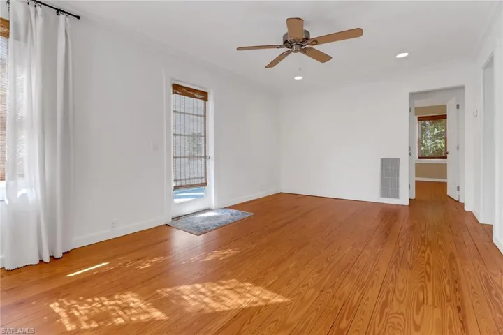 Unfurnished room with crown molding, ceiling fan, and light hardwood / wood-style floors