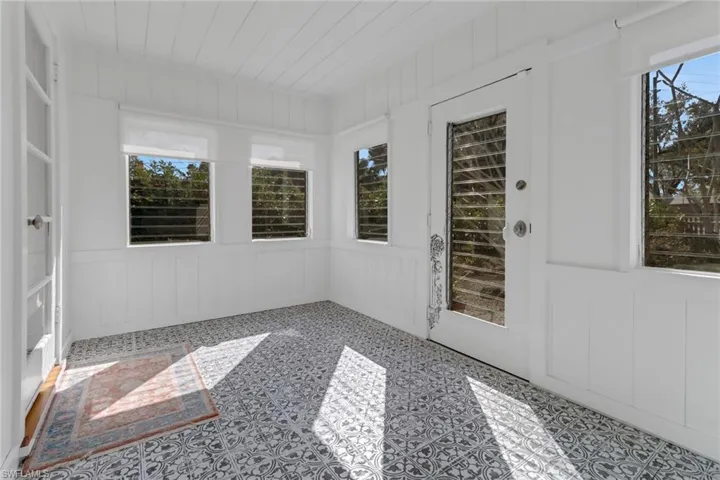 Unfurnished sunroom with wood ceiling
