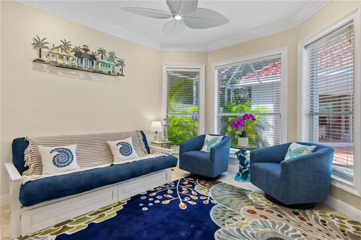 Sitting room with ornamental molding and a ceiling fan