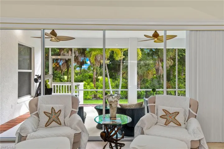 Sunroom featuring ceiling fan and plenty of natural light