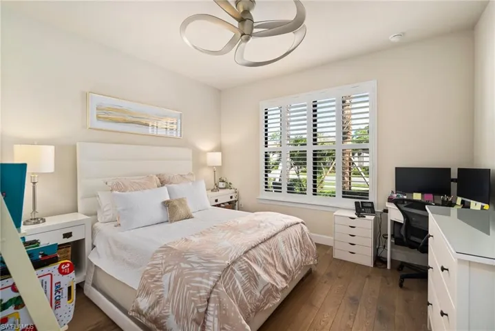 Bedroom featuring ceiling fan and dark hardwood / wood-style flooring