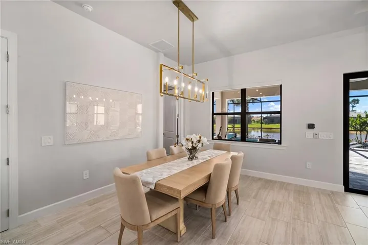 Dining room with light hardwood / wood-style flooring, an inviting chandelier, and a healthy amount of sunlight