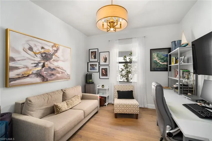 Office featuring light hardwood / wood-style flooring and a notable chandelier