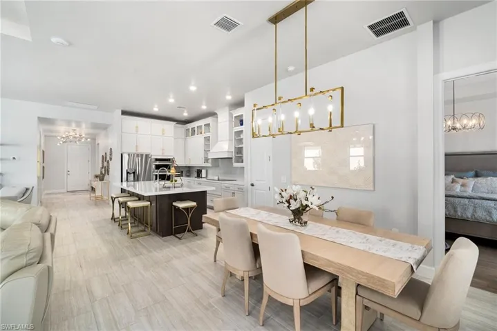 Dining area with sink and a notable chandelier