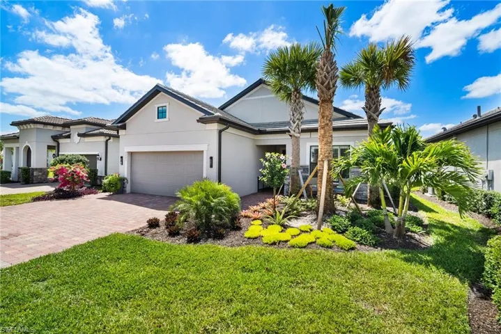 View of front facade with a front yard and a garage