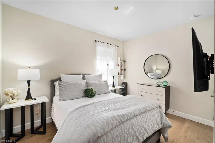 Bedroom with hardwood / wood-style floors