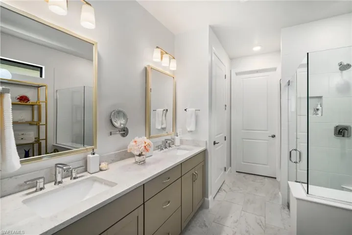 Bathroom featuring a shower with door and vanity