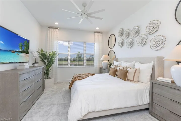 Carpeted bedroom with ceiling fan