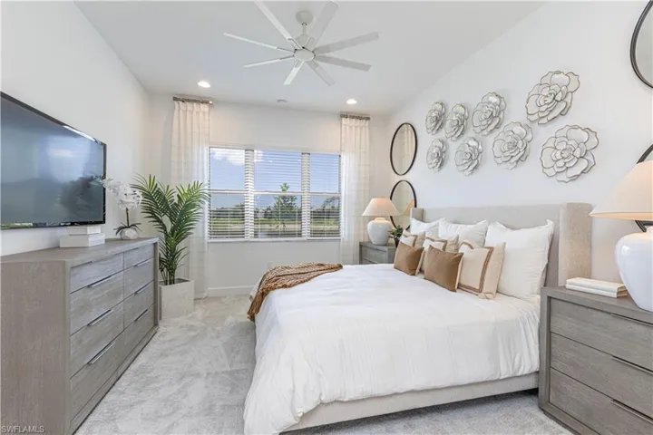 Bedroom with light carpet and ceiling fan