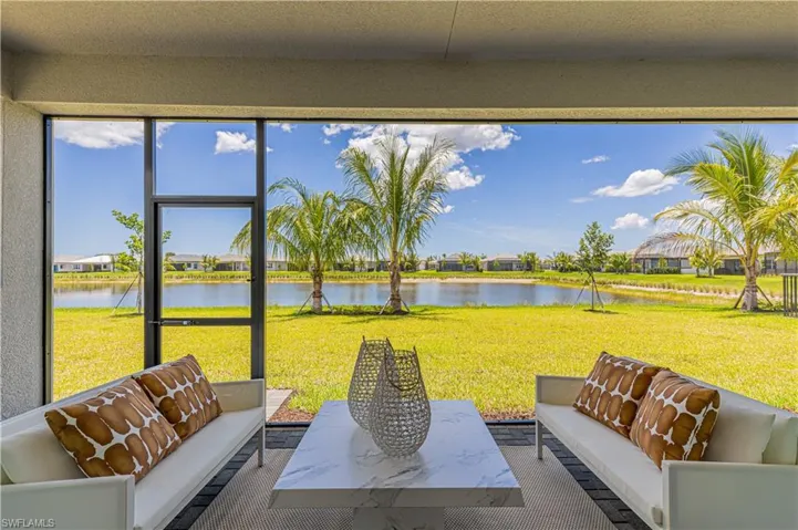 Sunroom featuring a water view