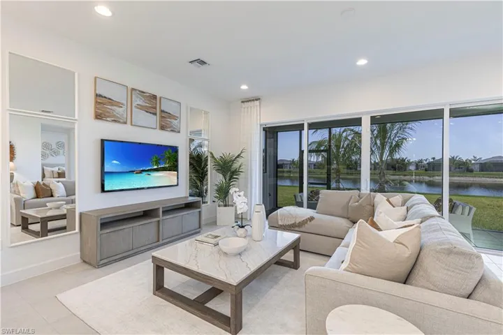 Living room featuring light tile flooring and a water view