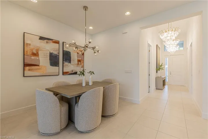 Dining area featuring a notable chandelier and light tile floors