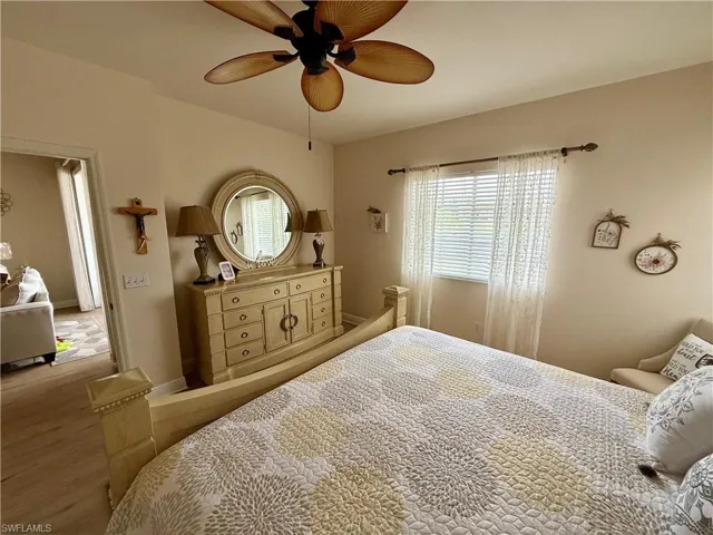 Bedroom with wood finished floors and ceiling fan