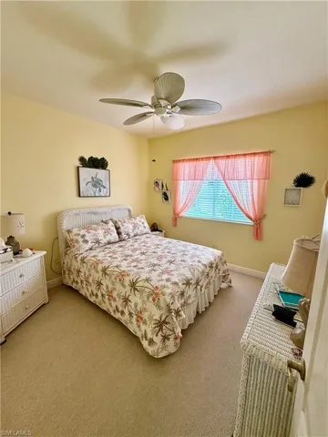 Bedroom featuring carpet, a ceiling fan, and baseboards