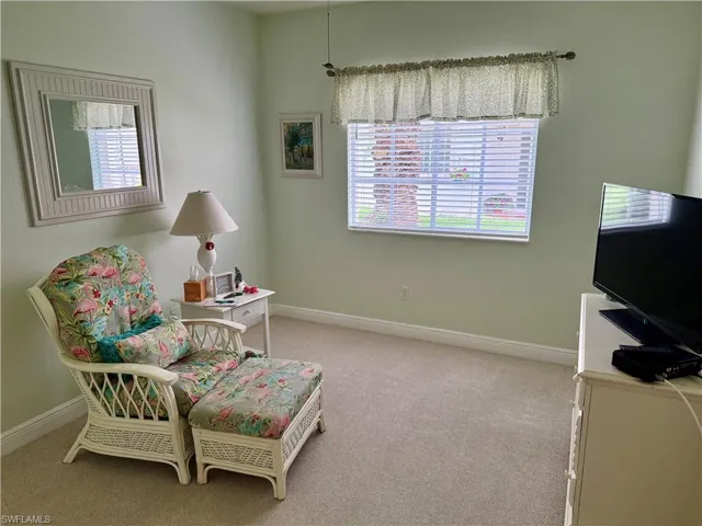 Sitting room featuring light colored carpet and baseboards