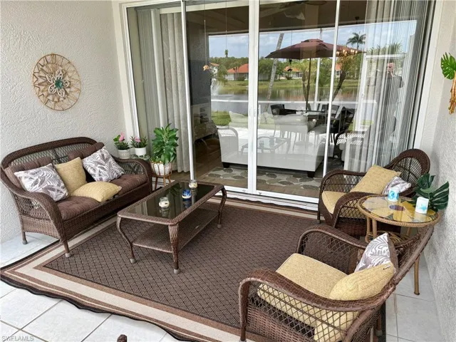 Sunroom with plenty of natural light and a water view