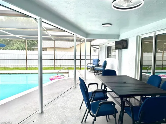 Sunroom with a patio, outdoor dining area, and healthy amount of natural light