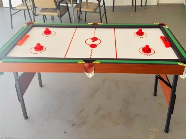 Recreation room with billiards table and concrete flooring