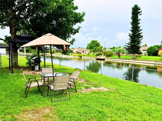 View of yard with a water view and a patio