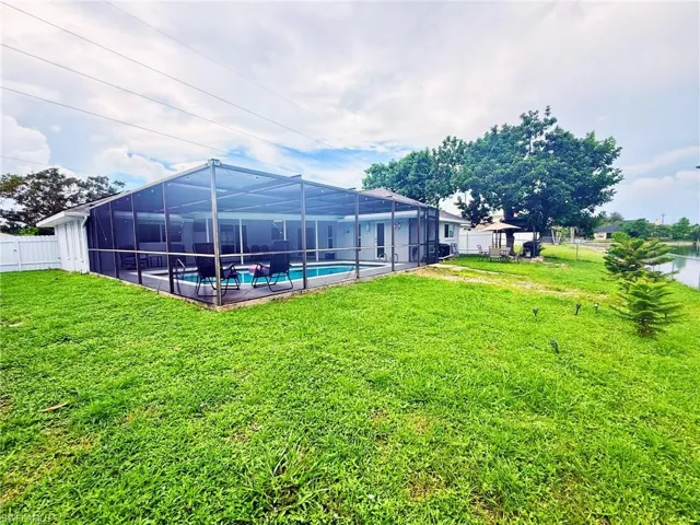 Fenced backyard with a sunroom and glass enclosure