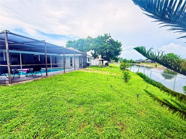 Fenced backyard with a sunroom, glass enclosure, and a patio area