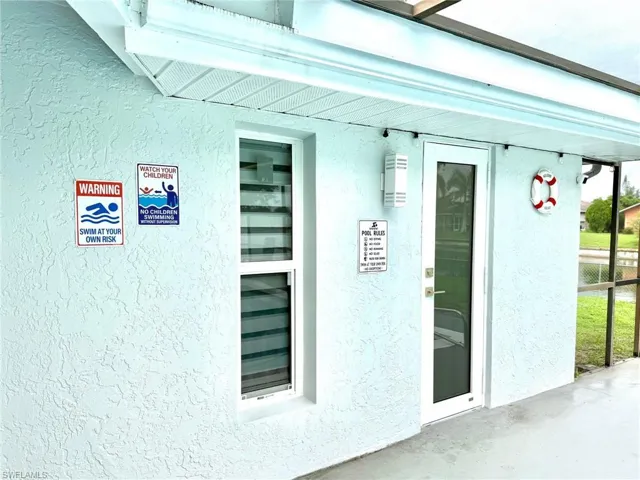 Property entrance featuring stucco siding