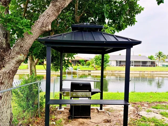 View of community with a water view and a gazebo