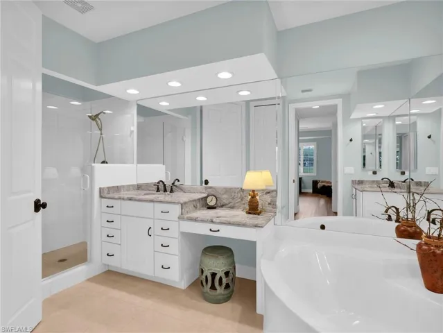 Primary Bathroom with separate water closet and walk in tile shower