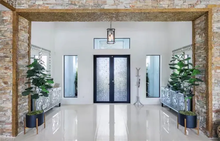 Foyer entrance featuring french doors and a high ceiling