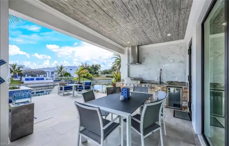 View of patio featuring outdoor dining area and area for grilling