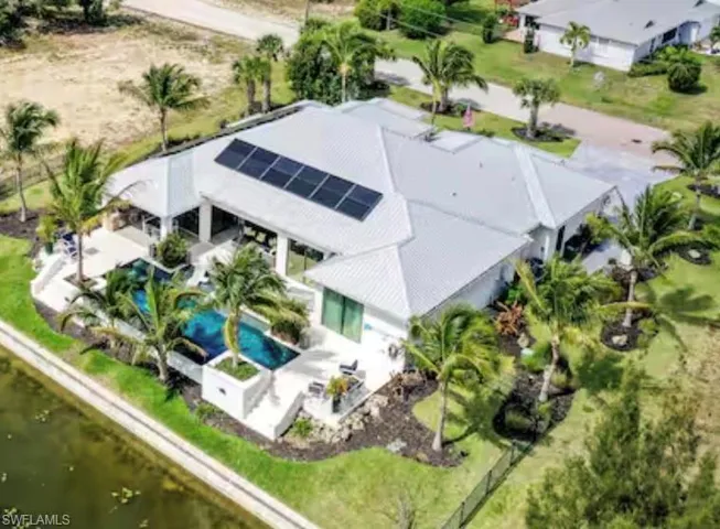 Aerial view of property and surrounding area featuring a pool