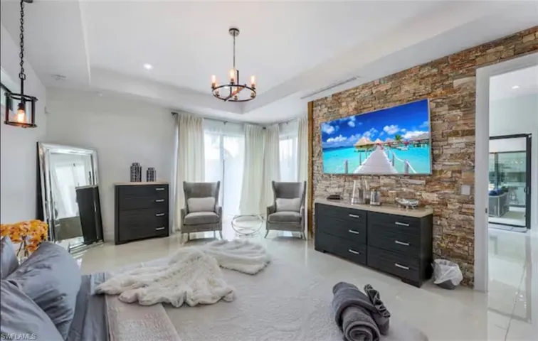 Living room with a chandelier and a tray ceiling