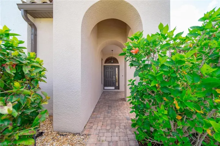 Property entrance featuring stucco siding