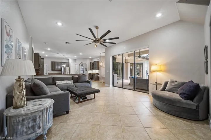 Living area featuring visible vents, recessed lighting, light tile patterned floors, and a ceiling fan