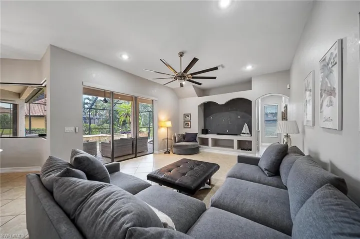 Living area with light tile patterned floors, recessed lighting, a ceiling fan, and baseboards