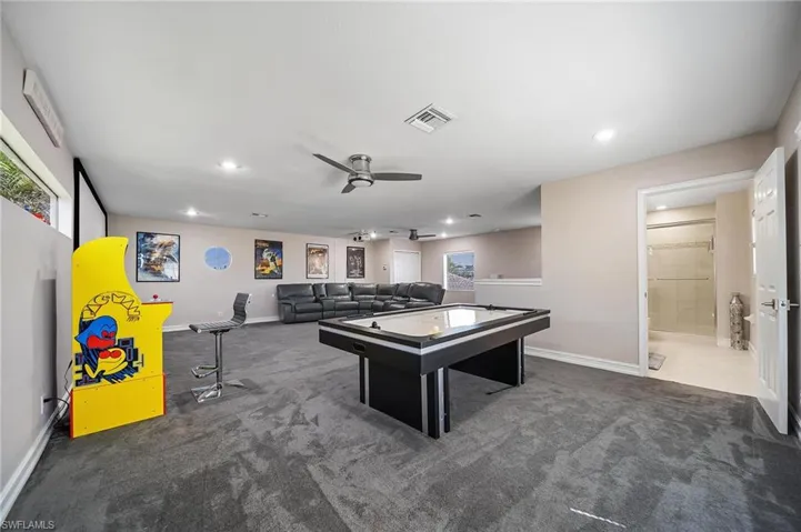 Game room featuring baseboards, visible vents, a ceiling fan, and carpet floors