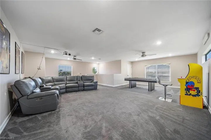 Carpeted living room featuring billiards, recessed lighting, visible vents, and baseboards