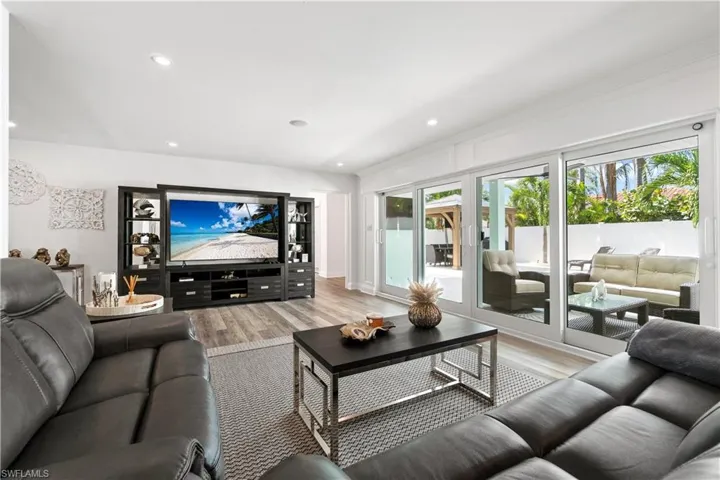 Living room with wood finished floors and recessed lighting