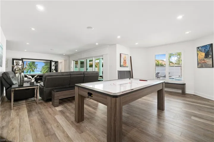 Game room with light wood-type flooring and recessed lighting