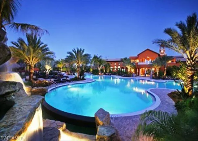 View of community pool at dusk