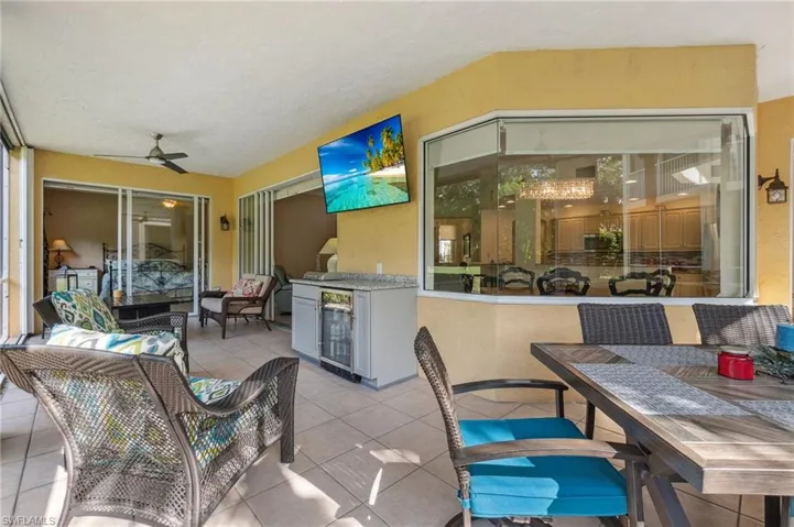 View of patio with wine cooler, ceiling fan, and exterior kitchen