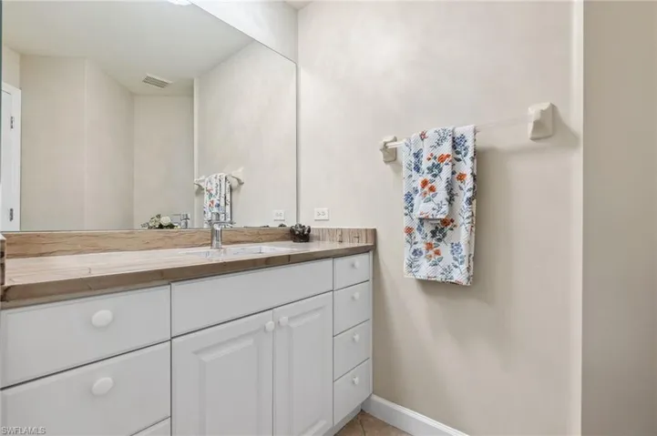 Bathroom with tile patterned flooring and vanity