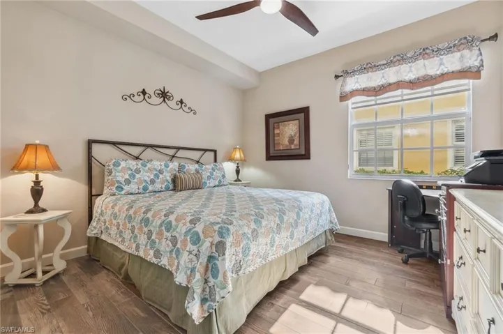 Bedroom featuring hardwood / wood-style flooring and ceiling fan